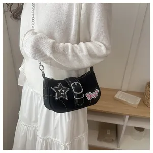 Y2K style black baguette shoulder bag with star patch and chain strap detail view