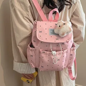 Stylish pink polka dot backpack for women featuring cute bow design and plush star keychain