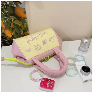 Nahaufnahme einer süßen Hand-Kosmetiktasche mit pastellrosa und gelber Stickerei