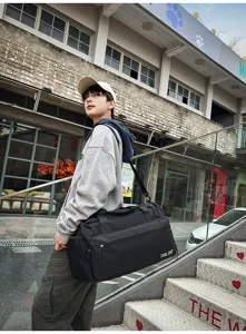 Durable black travel duffel bag with large capacity, ideal for gym and sports use.
