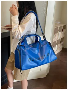 Blue sports duffel bag waterproof gym travel bag with custom logo and shoulder strap for fitness.
