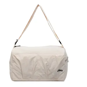 Minimalist beige travel duffel bag with large capacity, comfortable straps and practical front pockets.