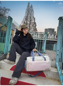 Detailed outdoor view of colorblock travel duffel gym bag showcasing large capacity.