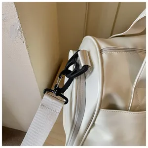 Detail view of the white fitness travel duffel bag strap hook and side buckle design.