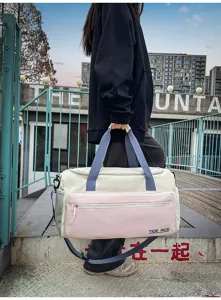 Color-block travel duffel bag with large capacity and multi-pockets for fitness sports.