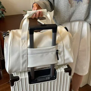 Waterproof leather travel duffel bag with luggage sleeve for gym and weekend trips.
