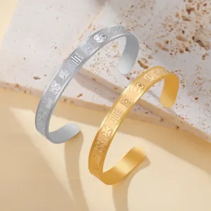 Detailed view of silver and gold plated 8mm bangles with African Adinkra symbols