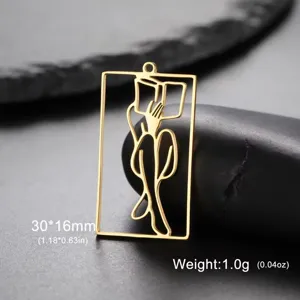 Macro detail of gold girl reading silhouette pendant in stainless steel, 30x16mm size.
