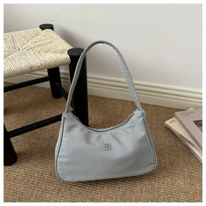 Elegant minimalist light blue nylon underarm shoulder bag with clover metal logo detail