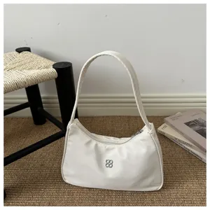 Elegant cream white underarm shoulder bag with minimalist silver clover logo detail