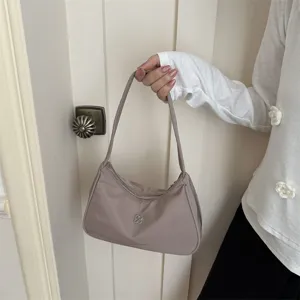 Minimalist nylon underarm shoulder bag for women in elegant mauve with flower detail