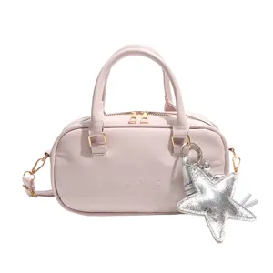 Elegant pink Boston handbag featuring a silver star charm and adjustable crossbody strap