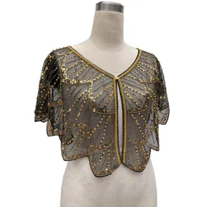 Detail view of vintage black mesh shawl featuring golden sequins and elegant beadwork