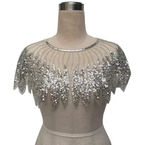 Detail view showing intricate silver sequin and beadwork on a retro evening dress capelet
