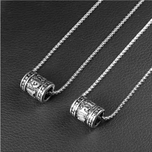 Close-up detail of vintage stainless steel necklaces with Six-Syllable Mantra pendants
