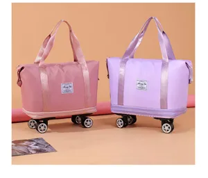 Detailed view of two large capacity travel bags with wheels in pink and purple colors.
