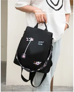 Black Oxford backpack with delicate floral embroidery and anti-theft design