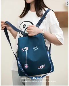 Dark blue anti-theft backpack for women featuring delicate floral embroidery detail