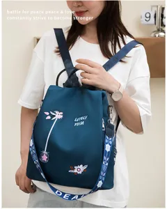 Stylish teal backpack with elegant floral embroidery and anti-theft design for women