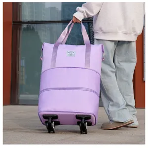 Detail of large lavender foldable travel bag with universal wheels and sturdy handle