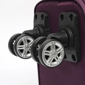 Close-up of durable 360-degree swivel wheels on a purple folding travel bag