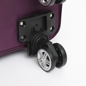 Close-up detail of 360-degree swivel wheels on a purple large capacity travel bag