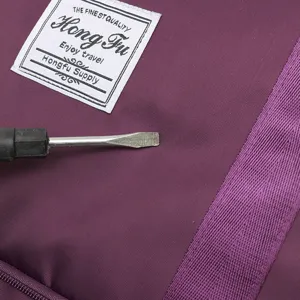Close-up of durable purple fabric on travel luggage bag showing scratch resistance
