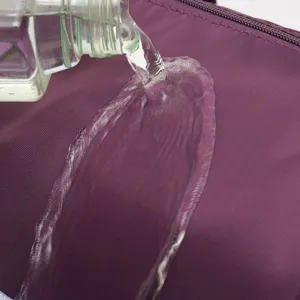 Detail view showing waterproof fabric of purple large capacity folding travel bag