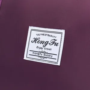 Close-up of 'Hong Fu' woven brand label on purple travel bag fabric