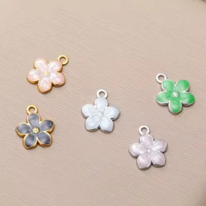 Detail view of colorful stainless steel enamel flower charms for DIY jewelry making.