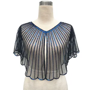 Detailed view of vintage sequined shrug with blue beads on black mesh fabric