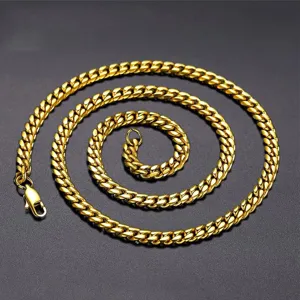 Detailed macro view of a 18K gold-plated stainless steel Cuban link necklace for men.