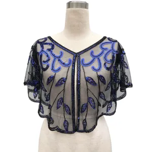 Detailed view of vintage black mesh shawl with blue sequins and beaded patterns.