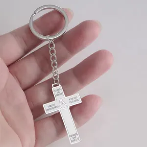 Detail view of 304 stainless steel cross pendant keychain with engraved French religious text
