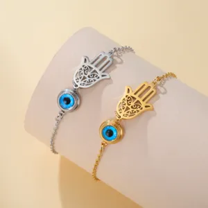 Detailed view of Hamsa Hand of Fatima and Evil Eye charm bracelets in gold and silver finish