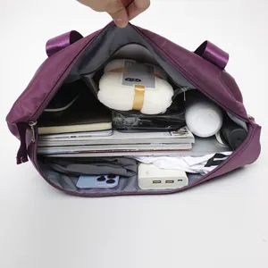 Detailed view showing the large interior capacity of the purple travel bag with travel essentials