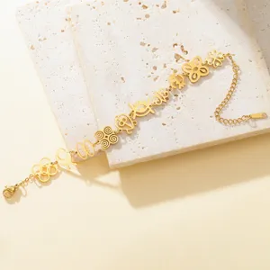 Close-up of gold stainless steel bracelet with delicate African Adinkra symbol cutouts