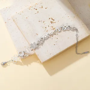 Detailed view of hollow-cut African Adinkra symbols on silver stainless steel bracelet
