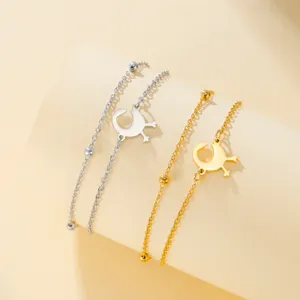 Close-up detail of gold and silver African Gye Nyame symbol bracelets in stainless steel