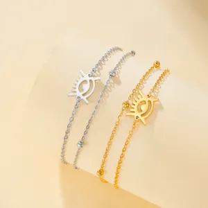 Detailed shot of gold and silver stainless steel bracelets with African Adinkra symbol
