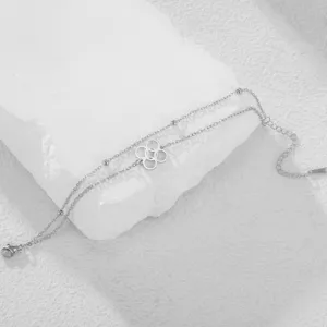 Detailed view of double-layered stainless steel bracelet featuring an African symbol pendant