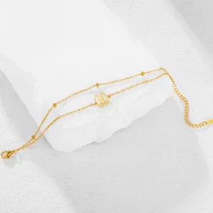Detailed macro view of gold-plated stainless steel bracelet with unique African symbol