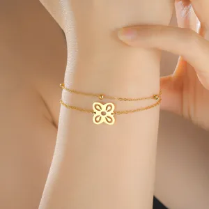 Gold-plated stainless steel double-layer bracelet featuring an African symbol charm on wrist