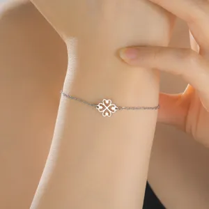 Detailed view of a silver African symbol stainless steel bracelet worn on a wrist
