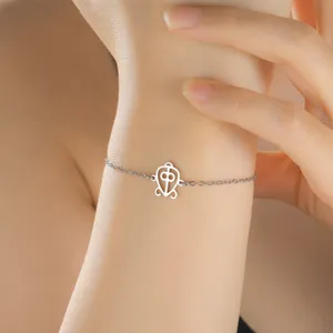 Macro detail of adjustable stainless steel bracelet featuring an African Adinkra symbol