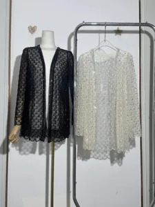 Detailed view of luxury heavy beadwork lace cardigan with sparkling sequins in black and white