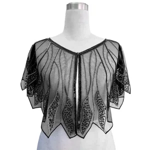 Detailed view of a vintage 1920s black mesh shawl with intricate silver sequin patterns