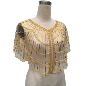 Detailed view of a vintage gold sequined evening shawl with elegant bead embroidery details