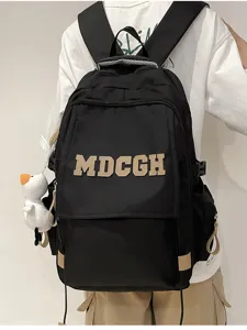 Détail du sac à dos noir avec lettrage MDCGH et pendentif en forme de canard