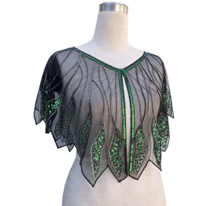 Detailed view of a vintage 1920s black mesh cape with green sequins and beadwork.